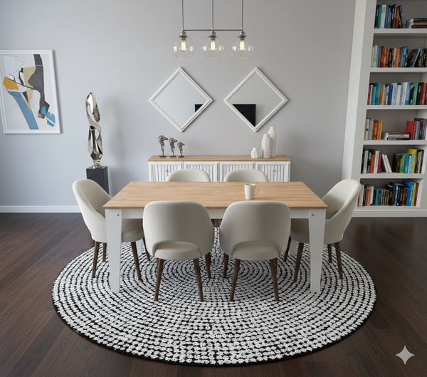 Whity Sleek Dining Room Set with wooden table and chairs on a round rug, bookshelf, and wall art.

