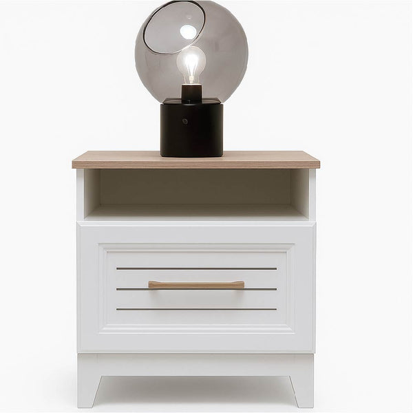 Whity White nightstand with wooden top and drawer, featuring a decorative lamp.

